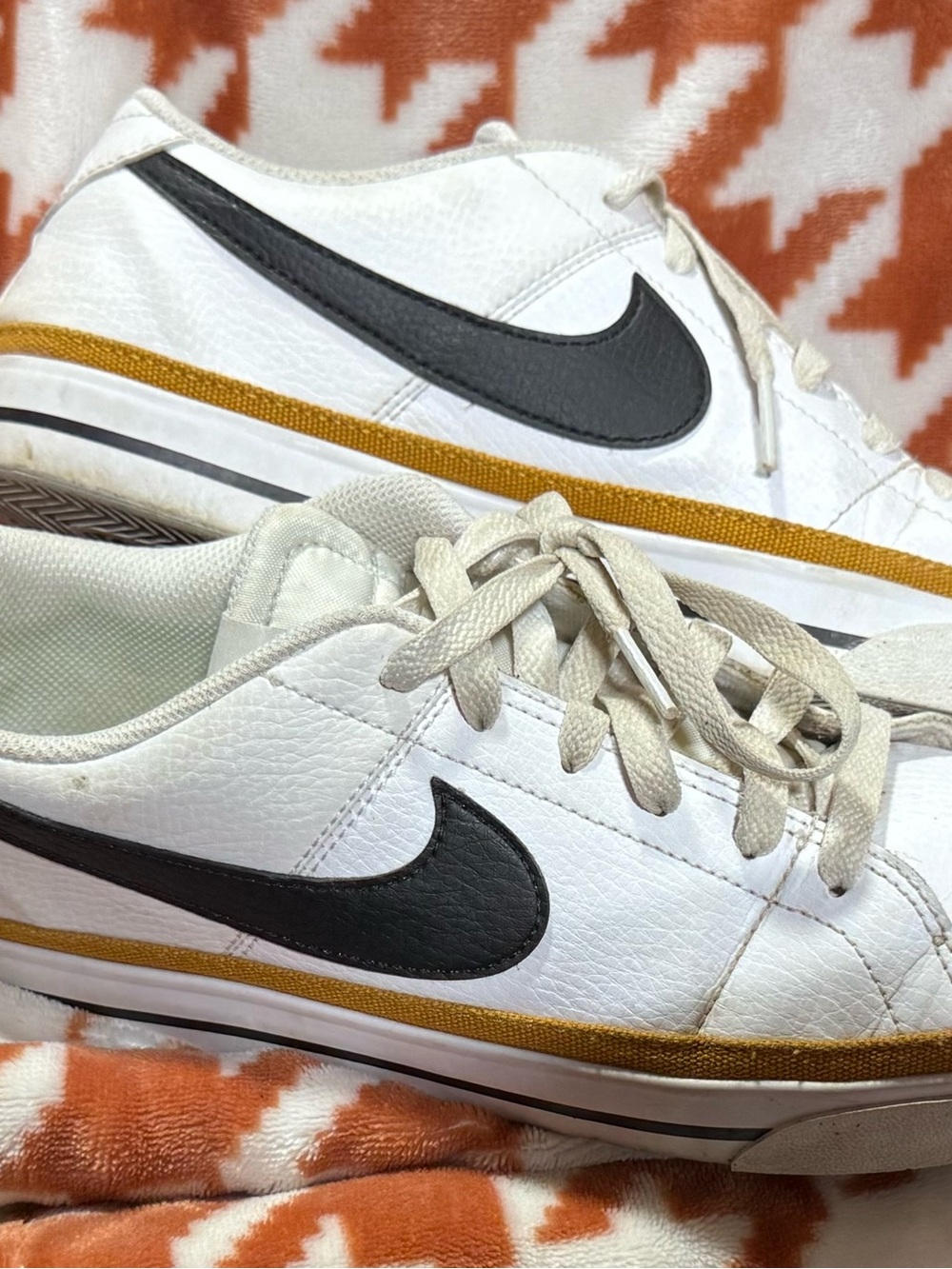 Nike Women’s White Sneakers with Black Swoosh and Gold Stripe